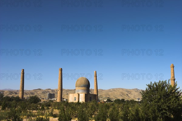 AFGHANISTAN, Herat, "The Mousallah Complex, Gaur Shad 's Mausoleum Part of the Mousallah Complex which included the remains of an old madrassa built by Queen Gaur Shad in 1417, wife of Timurid ruler Shah Rukh, son of Tamerlane,. There were several minarets in this complex but six were demolished by British troops in 1885, 3 were destroyed by earthquakes There are 6 remaining minarets one stands by the mausoleum with a mortar hole in it, another one also near the mausoleum is partly destroyed and four stand marking the corners of the long gone Madrassa built by Sultan Husain Baiquara last of the Timurid rulers"