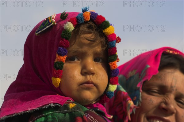 AFGHANISTAN, Mazar-I-Sharif, "Mother and daughter, Shrine of Hazrat Ali (who was assissinated in 661) This shrine was built here in 1136 on the orders of Seljuk Sultan Sanjar, destroyed by Genghis Khan and rebuilt by Timurid Sultan Husain Baiqara in 1481, since restored. The shrine is famous for its white pigeons, it is said the site is so holy that if a grey pigeon flies here it will turn white within 40 days"