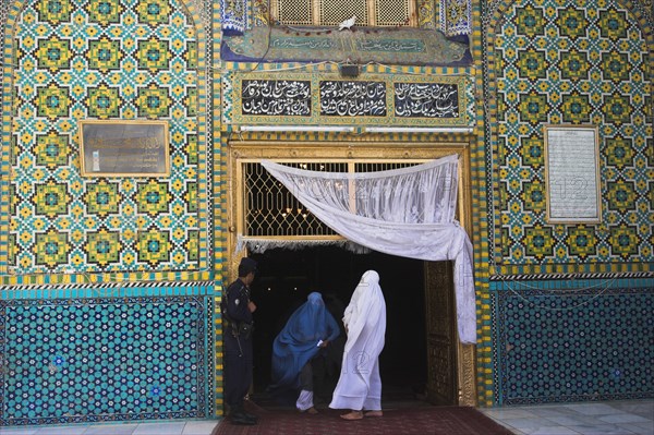 AFGHANISTAN, Mazar-I-Sharif, "Pilgrims at the Shrine of Hazrat Ali (who was assissinated in 661) This shrine was built here in 1136 on the orders of Seljuk Sultan Sanjar, destroyed by Genghis Khan and rebuilt by Timurid Sultan Husain Baiqara in 1481, since restored. The shrine is famous for its white pigeons, it is said the site is so holy that if a grey pigeon flies here it will turn white within 40 days"