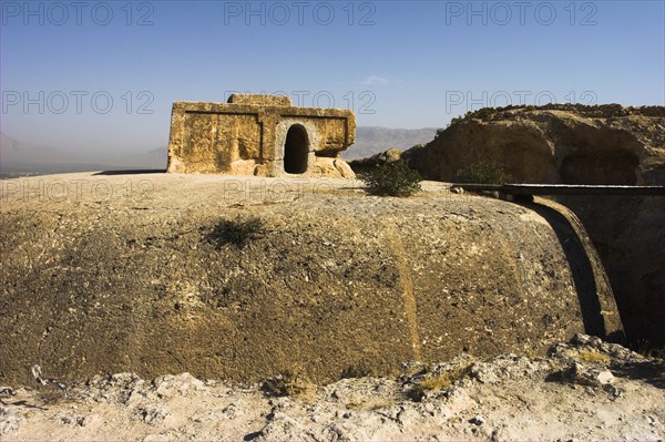 AFGHANISTAN, Samangan Province, Top-I-Rustam, "2km south of the centre of Haibak, Buddhist stupa carved out of rock known as Top-I-Rustam (Rustam's throne) an early burial mound that contained relics of the Buddha, part of a stupa-monastery complex carved from rock dating from the Kushano-Sasanian period 4th-5th century AD. The stupa is situated above caves where the monks lived  Jane Sweeney"