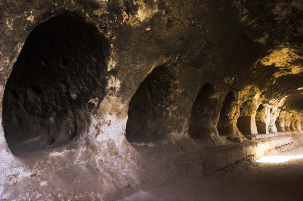 AFGHANISTAN, Samangan Province, Top-I-Rustam, "2km south of the centre of Haibak, Buddhist caves know as Takht-I-Rusam (Rustam's throne), part of a stupa-monastery complex caeved from rock dating from the Kushano-Sasanian period 4th-5th century AD. Corridor off which the monks' living quarters are carved in cave 2 The caves are situated below the stupa and are where monks lived"