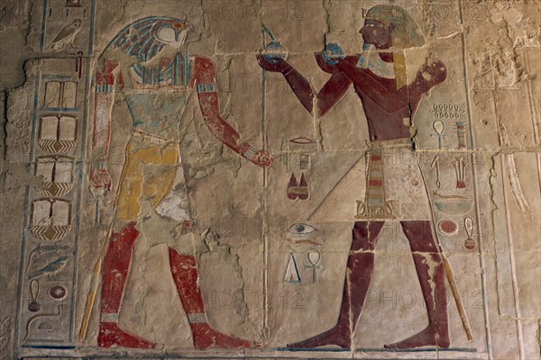 EGYPT, Nile Valley, Thebes, Deir-el-Bahri. Hatshepsut Mortuary Temple. Chapel of Anubis. Relief of Tuthmosis III making offerings to the sun god Ra- Harakhty.