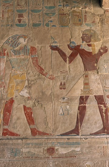 EGYPT, Nile Valley, Thebes, Deir-el-Bahri. Hatshepsut Mortuary Temple. Chapel of Anubis. Relief of Tuthmosis III making offerings to the sun god Ra- Harakhty.