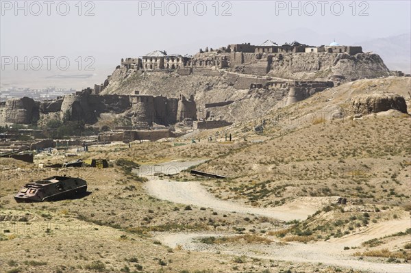 AFGHANISTAN, Ghazni, Military graveyard with ancient city walls and Citadel in background (the Citadel was destroyed during First Anglo Afghan war since rebuilt and still used as a military garrison)