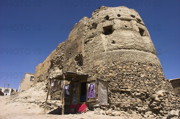 AFGHANISTAN, Ghazni, Shop next to the ancient walls of Citadel destroyed during First Anglo Afghan war since rebuilt still used as a military garrison Jane Sweeney
