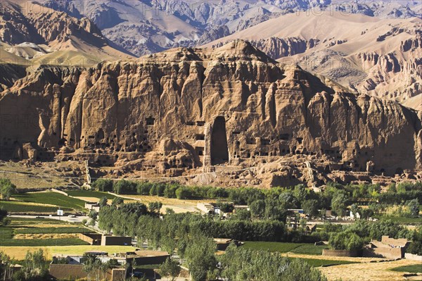 AFGHANISTAN, Bamiyan Province, Bamiyan, View of Bamiyan valley and village showing cliffs with empty niche where the famous carved Budda once stood (destroyed by the Taliban in 2001)