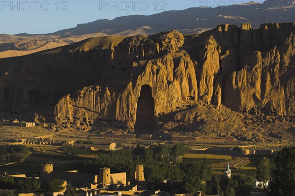 AFGHANISTAN, Bamiyan Province, Bamiyan, View of Bamiyan valley and village showing cliffs with empty niche where the famous carved Budda once stood (destroyed by the Taliban in 2001)