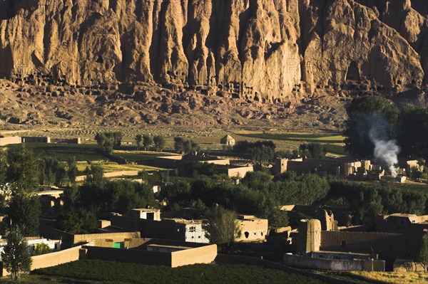 AFGHANISTAN, Bamiyan Province, Bamiyan, Village at base of cliffs near empty niche where the famous carved Budda once stood (destroyed by the Taliban in 2001)