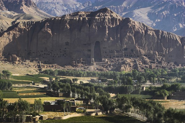 AFGHANISTAN, Bamiyan Province, Bamiyan, View of Bamiyan valley and village showing cliffs with empty niche where the famous carved Budda once stood (destroyed by the Taliban in 2001)