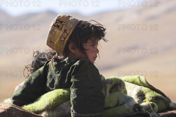 AFGHANISTAN, Desert, "Kuchie nomad camel train, between Chakhcharan and Jam, Children on top of camel"