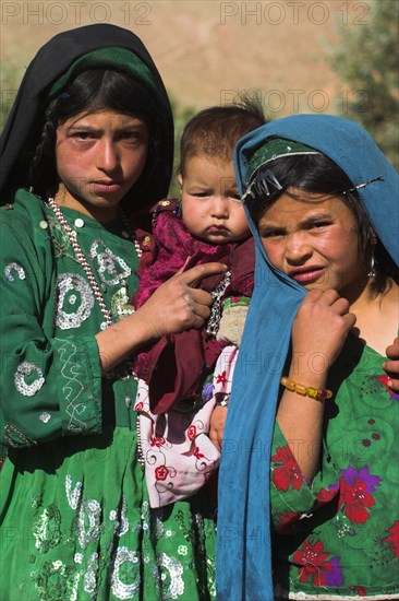 AFGHANISTAN, Ghor Province, Pal-Kotal-i-Guk, "Aimaq nomad camp, Aimaq girls and baby in front of yurt