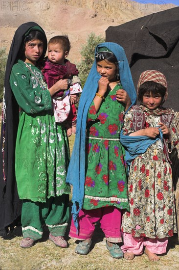 AFGHANISTAN, Ghor Province, Pal-Kotal-i-Guk, "Aimaq nomad camp, Aimaq girls and baby in front of yurt