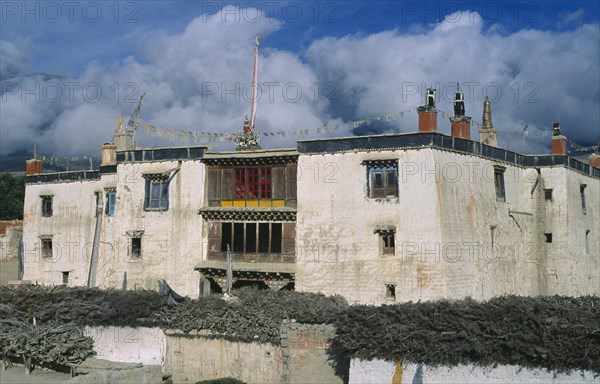 NEPAL, Mustang, Lo Manthang, "Present palace of King Jigme Palbar Bista.  Exterior with flat roof, shrine and prayer flags."