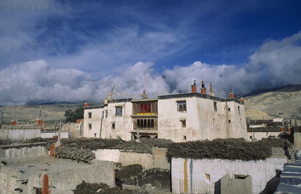 NEPAL, Mustang, Lo Manthang, "Present palace of King Jigme Palbar Bista.  Exterior with flat roof, shrine and prayer flags."