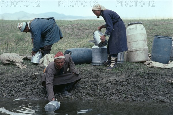 MONGOLIA, Agriculture, Mongolian herdsmen and woman fetching water.