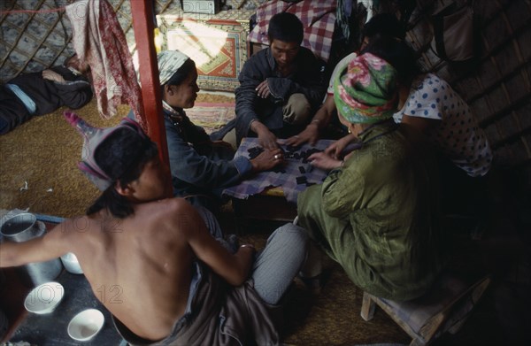 MONGOLIA, People, Playing game of dominoes inside yurt.