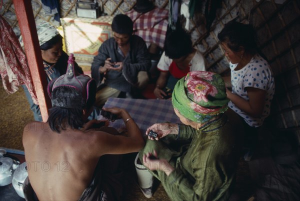 MONGOLIA, People, Playing game of dominoes inside yurt.