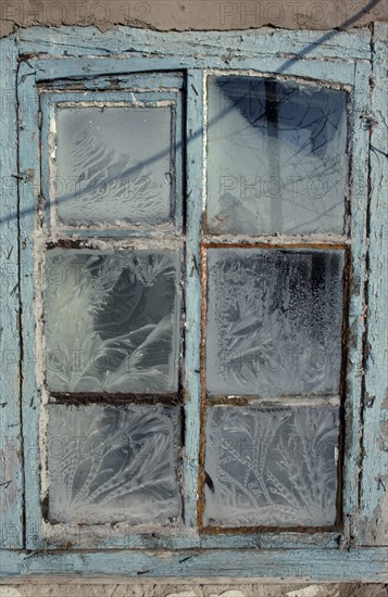 MONGOLIA, Architecture, Detail of window with pale blue painted frame and frost patterns decorating the panes.