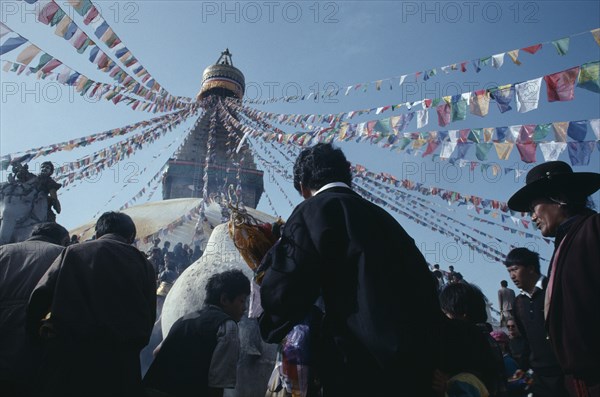 NEPAL, Bodhanath, "Crowds surrounding Bodhanath stupa hung with prayer flags during Loshar, the Tibetan New Year."