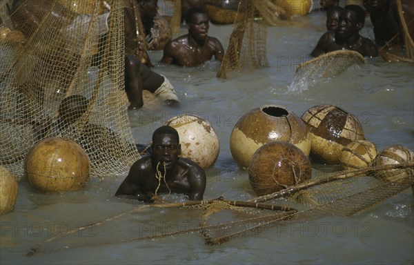 NIGERIA, North, Argungu, "Fishing Festival, men and nets in water at climax to three day festival."
