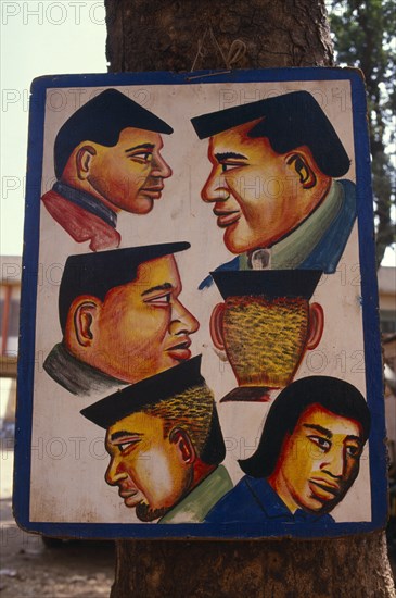 MALI, Bamako, Sign outside hairdresser’s shop advertising different hair cuts.