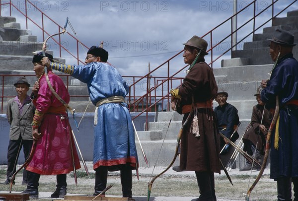 MONGOLIA, Ulan Bator, Nadam  National Day Ulan Bator stadium  three veteran competitors taking part in national archery competition. Ulaanbaatar East Asia Asian Baator Mongol Uls Mongolian Ulaan