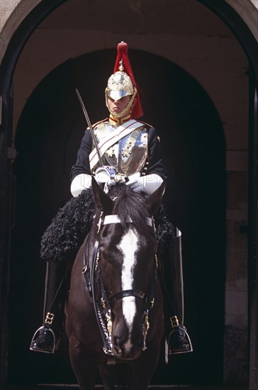 ENGLAND, London, "Whitehall, horse guard sitting on horse outside Horse Guards Parade."