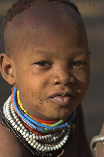 ETHIOPIA, Lower Omo Valley, Mago National Park, Karo girl wearing colourful necklaces.
