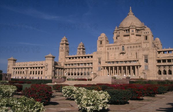 INDIA, Rajasthan, Jodhpur, Umaid Bhawan Palace exterior seen from across gardens