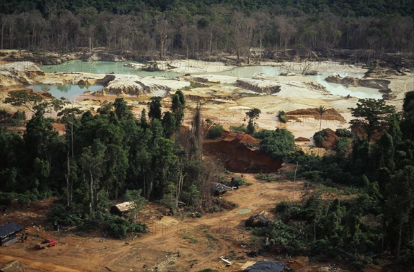 BRAZIL, Mato Grosso, Peixoto de Azevedo, Garimpo  small scale gold mining  on former Panara territory showing deforestation and pollution. Garimpeiro prospectors in informal economy have displaced tribal Panara Indians formerly known as Kreen-Akrore  Krenhakarore  Krenakore  Krenakarore  Amazon American Brasil Brazilian Ecology Entorno Environmental Environment Green Issues Kreen Akore Latin America Latino Scenic South America