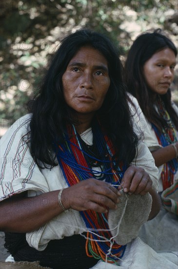 COLOMBIA, Sierra Nevada de Santa Marta, Ika, Ika widow Adelaida sewing traditional mochila shoulder bag from homespun sheeps' wool. Many stranded bead necklace signifies considerable wealth. Arhuaco Aruaco indigenous tribe American Classic Classical Colombian Colombia Hispanic Historical Indegent Latin America Latino Older South America  Arhuaco Aruaco indigenous tribe American Classic Classical Colombian Columbia Hispanic Historical Indegent Latin America Latino Older South America History One individual Solo Lone Solitary 1 Single unitary