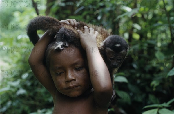 COLOMBIA, North West Amazon, Tukano Indigenous People, Portrait of young Makuna child with pet monkey. Tukano  Makuna Indian North Western Amazonia American Children Colombian Columbia Hispanic Indegent Kids Latin America Latino South America Tukano