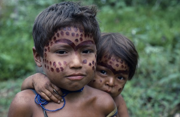 COLOMBIA, North West Amazon, Tukano Indigenous People, Portrait of two young Makuna children with dark red mixture of Achiote and we dye ceremonial face paint. Tukano Makuna Indian North Western Amazonia American Colombian Columbia Hispanic Indegent Kids Latin America Latino South America Tukano