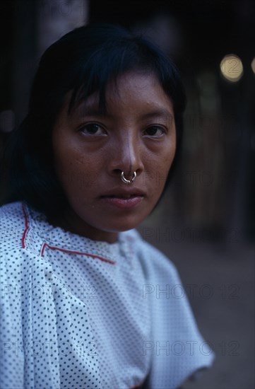 COLOMBIA, Darien, Kuna Indians, One of headman Josecito's grand-daughters wearing an old family gold nose ring  in Arquia community.  Cuna American Colombian Columbia Female Women Girl Lady Hispanic Latin America Latino South America