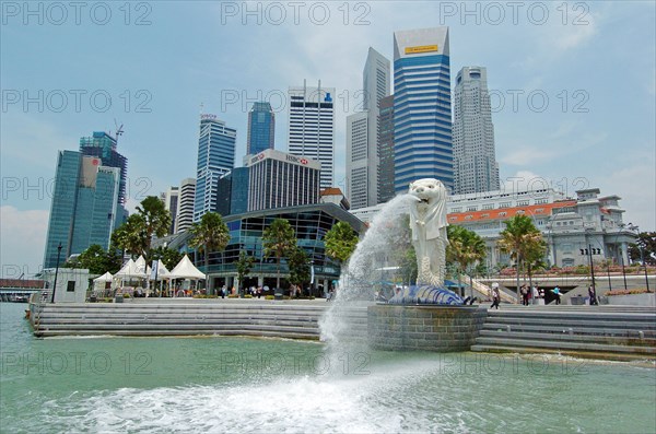 SINGAPORE, Financial District, "MERLION STATUE SITUATED INFRONT OF THE FULLERTON HOTEL AND FINACIAL DISTRICT BEHIND. The Merlion is one of the most well-known tourist icons of Singapore. Its landmark statue, once at the Merlion Park, was relocated to the front of the Fullerton Hotel in April 2002.In 2002, the statue was relocated to its current site that fronts Marina Bay with the completion of the Esplanade Bridge in 1997. The statue measures 8.6 metres high and weighs 70 tonnes. The merlion was designed by Fraser Brunner for the Singapore Tourism Board in 1964 and was used as its logo up to 1997. The Merlion continues to be its trademark symbol."