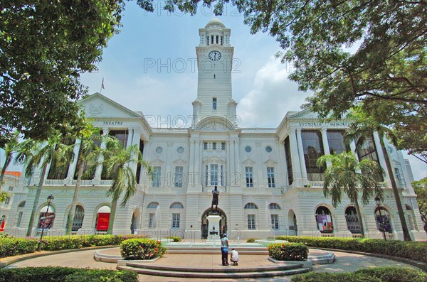 SINGAPORE, PARLIaMENT LANE, "VIEW OF THE VICTORIA THEATRE AND CONCERT Hall. The complex started off with the building of a town hall in 1862. Built during an era of Victorian Revivalism was occurring in Britain, its design reflected this architectural influence with Italianate windows and rusticated columns, and was the first building to reflect this style in Singapore's buildings. In 1901, construction for a neighbouring building began in memory of the late Queen Victoria, with the foundation laid in 1902 and officially opened by the Governor of the Straits Settlements, Sir John Anderson on 18 October 1905 as the Victoria Memorial Hall. The town hall was also heavily renovated and air-conditioned as the Victoria Theatre. In 1979, the memorial hall was renovated again to accommodate the Singapore Symphony Orchestra (SSO), upon which it was renamed as the Victoria Concert Hall. "