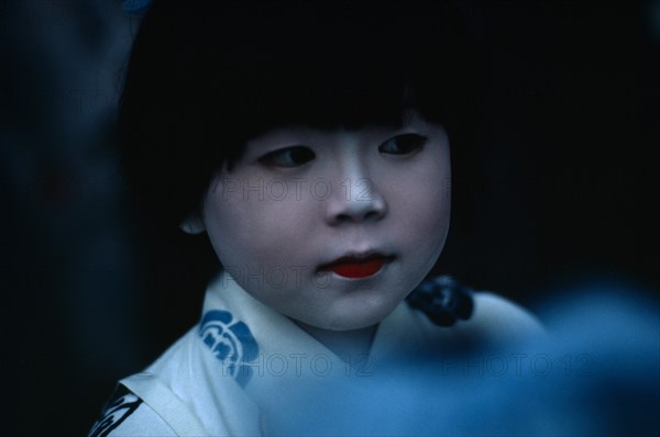 JAPAN, Honshu, Kyoto, Gion Festival.  Portrait of young girl with white painted face signifying purity and gentleness of birth.