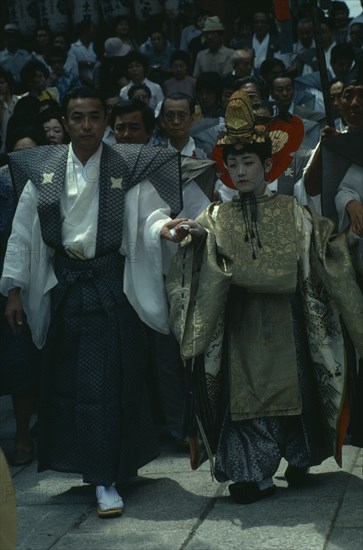 JAPAN, Honshu, Kyoto, "Gion Festival.  The ‘chigo’ the figure of greatest importance in the festival dressed in richly decorated silk robes of a Heian nobleman.  Prior to the Edo period the chigo was always the son of a samurai, but on this occasion he is the son of a well-known samurai actor Ikawa Hashizo.  "