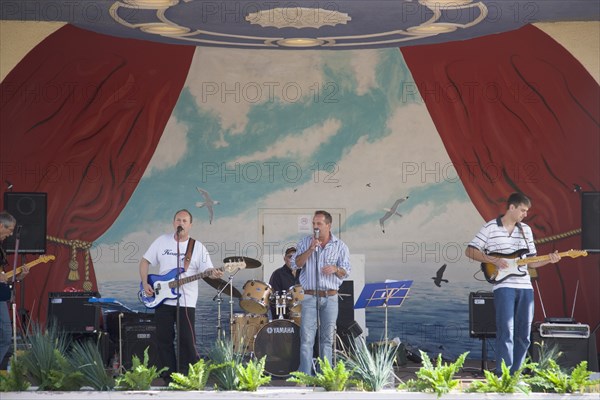 ENGLAND, West Sussex, Worthing, A band playing on stage in the Lido bandstand