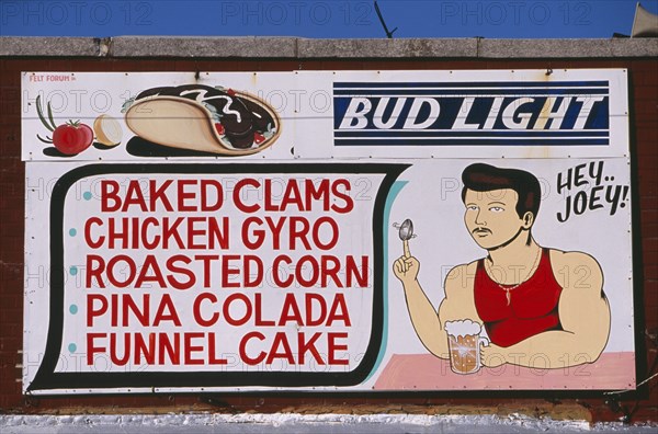 USA, New York, New York City, Coney Island.  Sign for cafe / bar listing food and drink  with painted illustrations of drinking man spinning a clam shell on his finger and American slang phrase ‘Hey Joey’.