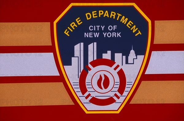 USA, New York, New York City, Detail of New York fire department badge on side of fire engine or truck.  Continues to depict city skyline including twin towers of the World Trade Centre.