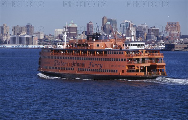 USA, New York, New York City, Staten Island ferry with city skyline beyond.