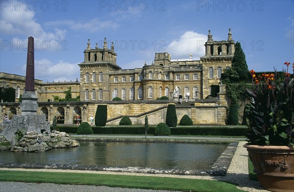 ENGLAND, Oxfordshire, Woodstock, Blenheim Palace. View across formal gardens towards the Bernini Fountain