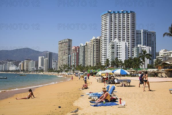 MEXICO, Guerrero State, Acapulco, "Condominiums and hotels beside beach, people sunbathing."