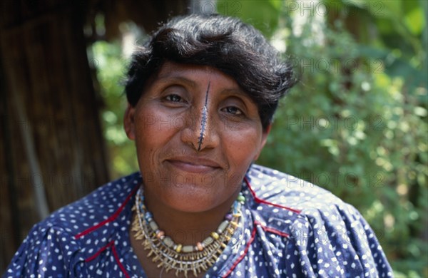 PANAMA, San Blas Islands Tikantiki , Kuna Indigenous Tribe, "Portrait of an older Kuna woman, the wife of the island chieftain, wearing a monkey tooth necklace with a black line drawn along length of nose.  Cuna"