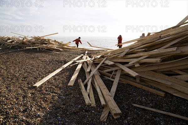 ENGLAND, West Sussex, Worthing, Timber washed up on the beach from the Greek registered Ice Princess which sank off the Dorset coast on 15th January 2008. People walk among the debris