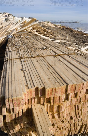 ENGLAND, West Sussex, Worthing, Timber washed up on the beach from the Greek registered Ice Princess which sank off the Dorset coast on 15th January 2008. Worthing Pier in the distance