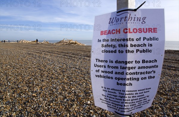 ENGLAND, West Sussex, Worthing, Timber washed up on the beach from the Greek registered Ice Princess which sank off the Dorset coast on 15th January 2008. A sign warns people to keep off the beach which they ignore