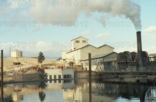 TUNISIA, Industry, Phosphates refinery near Metlaoui with plume of smoke rising from chimney at side.