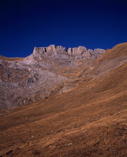 SPAIN, Aragon, Pyrenees, Sierra de la Escusana.  Mountain landscape with eroded rock pinnacles and layers of rock and scree.